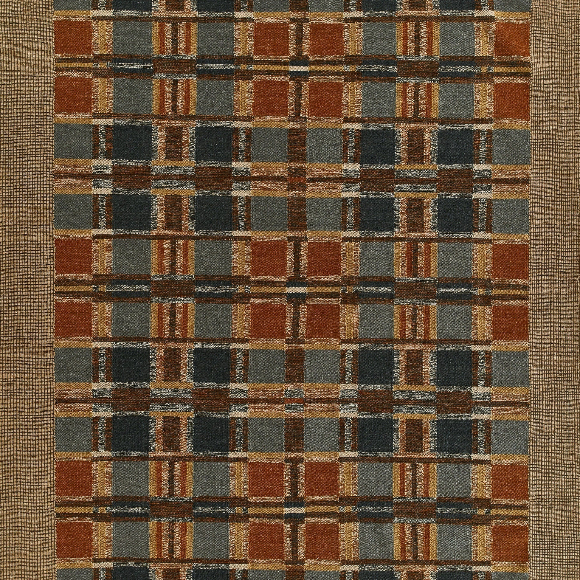 Rectangular woven rug with a rust-orange, slate blue, gray and tan plaid pattern, bordered by a natural beige frame.