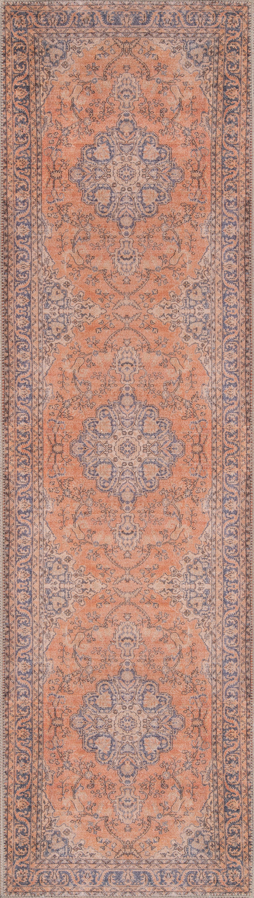 Peach-orange oriental area rug with blue-gray central medallions and scrolling floral border.