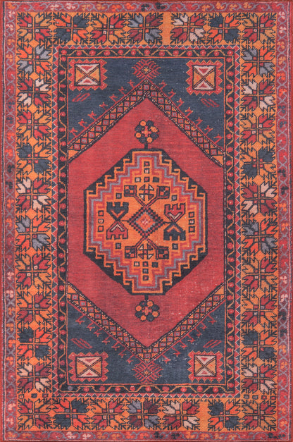 Red field oriental rug with navy corners, intricate geometric diamond medallion, and orange-bordered floral border.