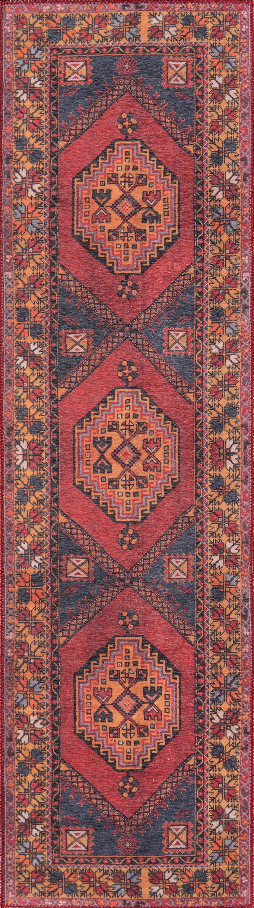 Handwoven wool runner rug with red field, three geometric diamond medallions, navy borders, and mustard floral border.