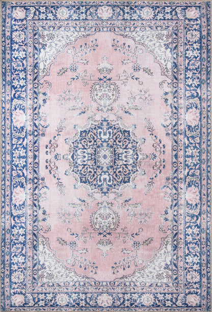 Pink field oriental rug with blue central medallion, navy border and ivory floral accents; Persian-inspired decorative rug.