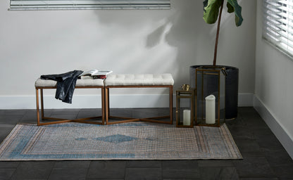 Blue-gray runner rug with a leather jacket, an open magazine, and lanterns.