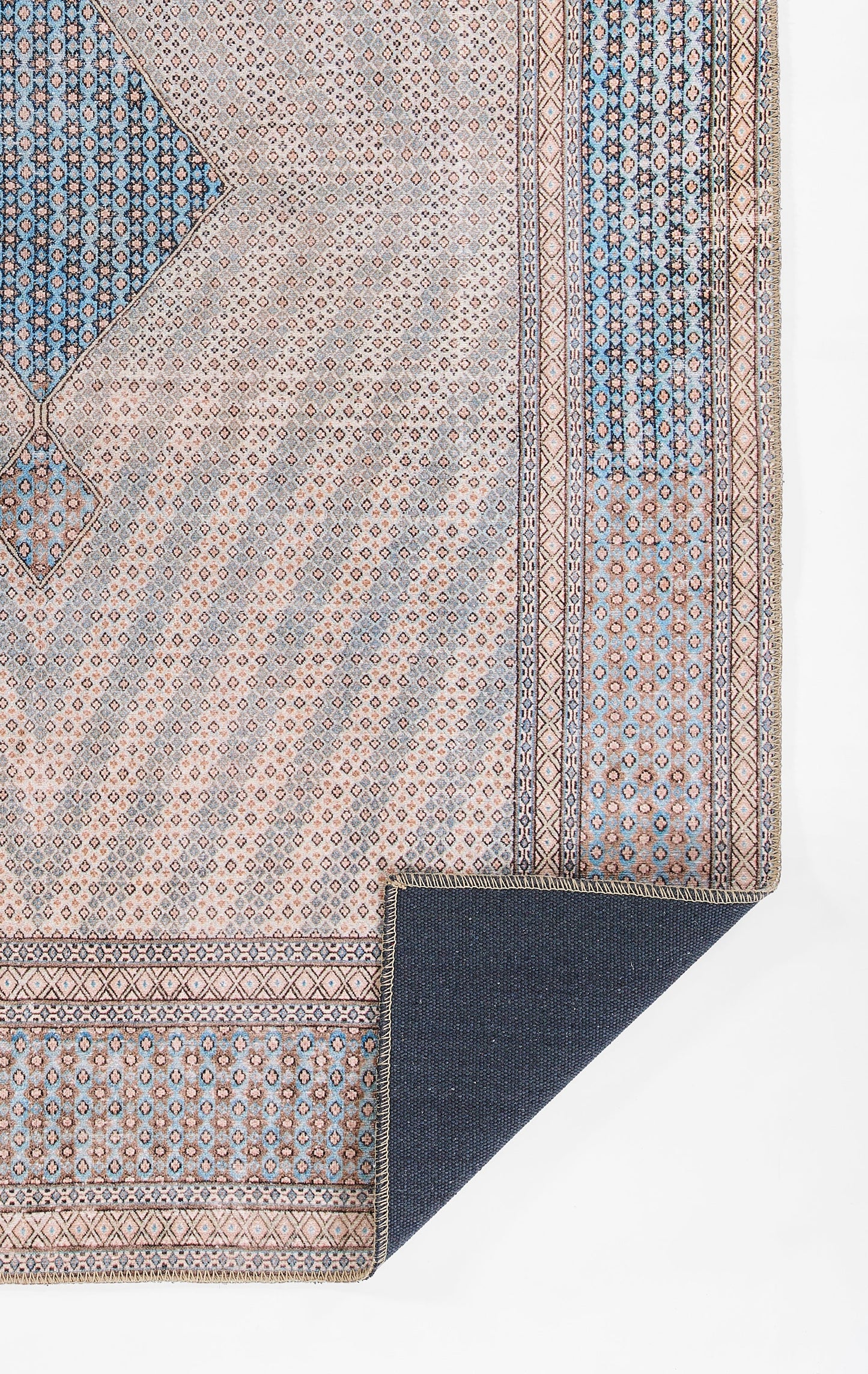 Blue and beige Persian-inspired woven runner with geometric medallions and borders; corner folded to reveal navy backing