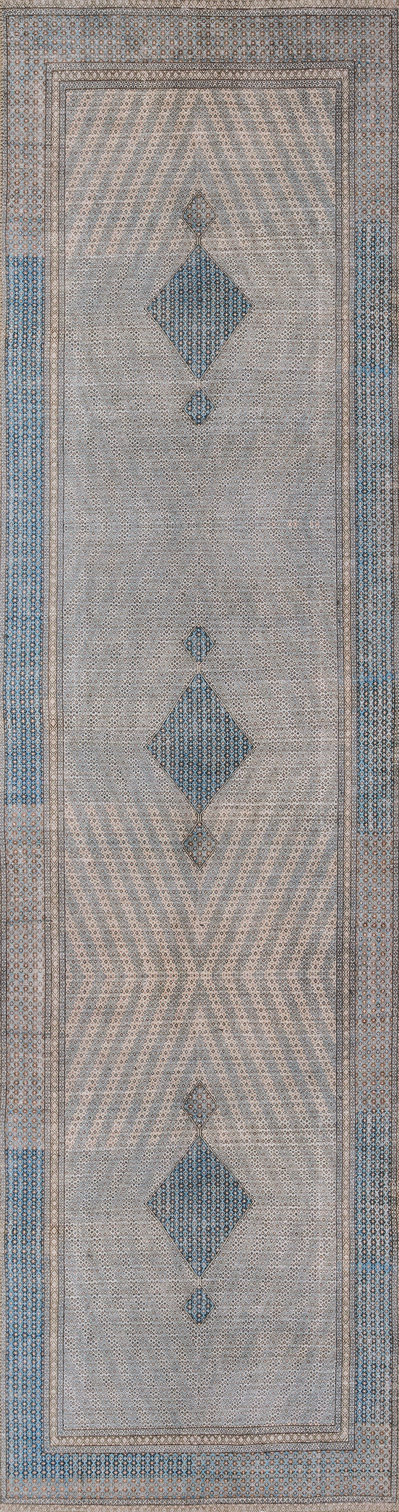 Long rectangular rug runner featuring blue diamond motifs on a gray-beige background with beige chevron borders.