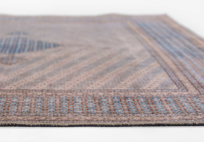 Blue and brown flat-weave runner rug with a geometric border; woven texture, modern living-room decor.