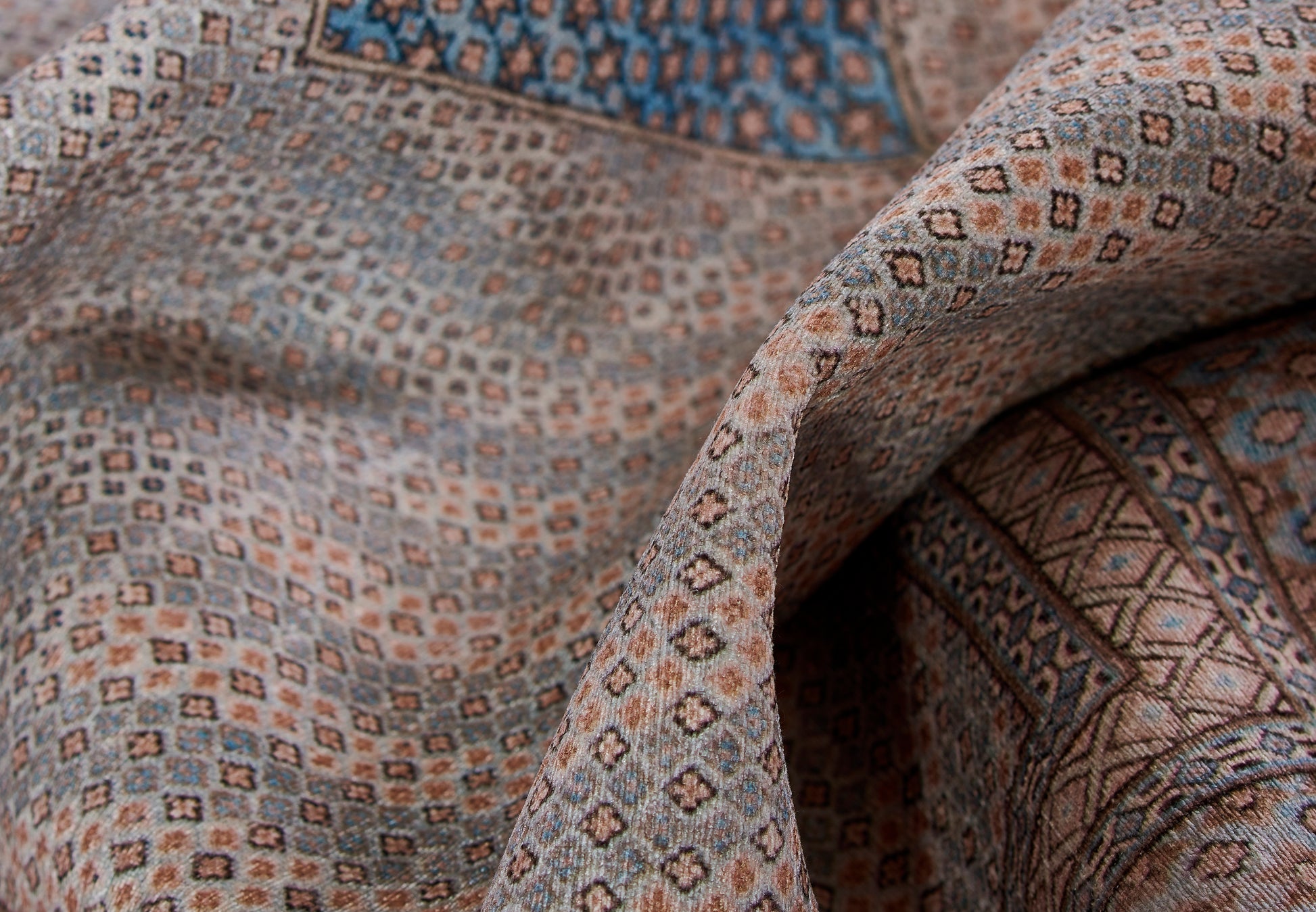 Soft woven rug runner with geometric diamond pattern in beige, brown, and blue, 2' x 8'.