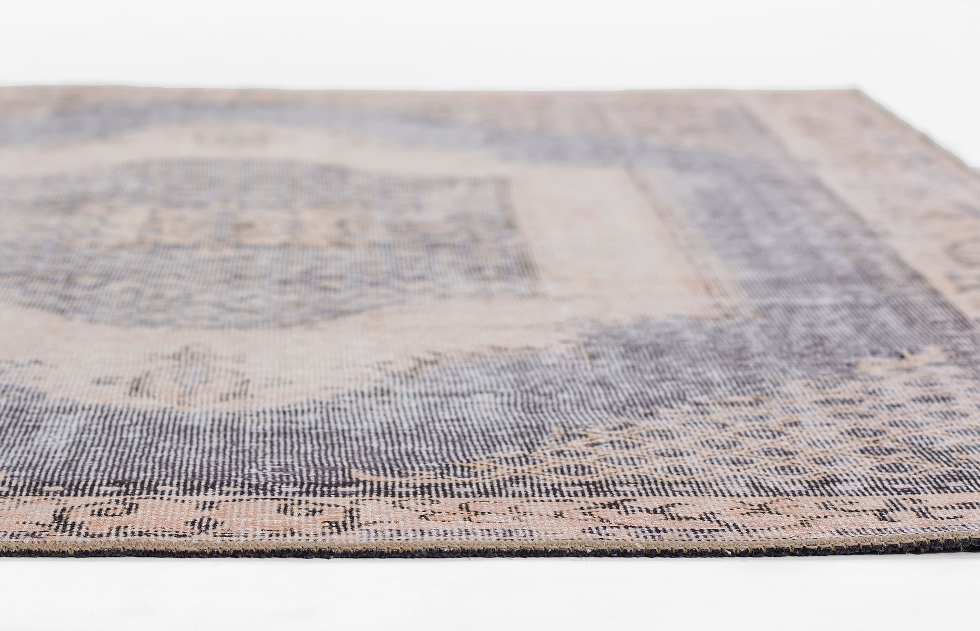 Close-up of a blue and beige distressed vintage woven area rug; rectangular and versatile for living room décor.