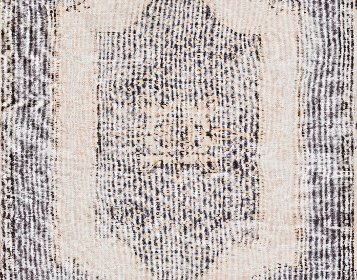 Rectangular blue & ivory distressed rug with central floral medallion and ornate border.
