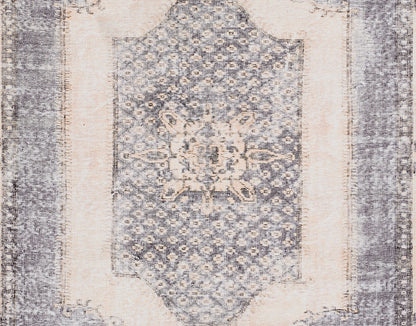 Rectangular blue & ivory distressed rug with central floral medallion and ornate border.