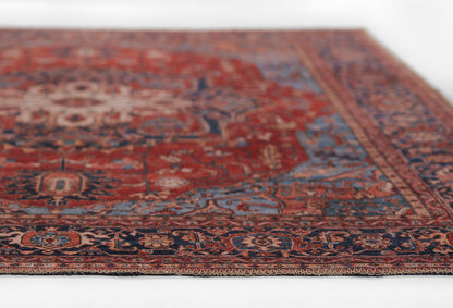 Red Persian-style rug with blue and ivory floral motifs and ornate border.