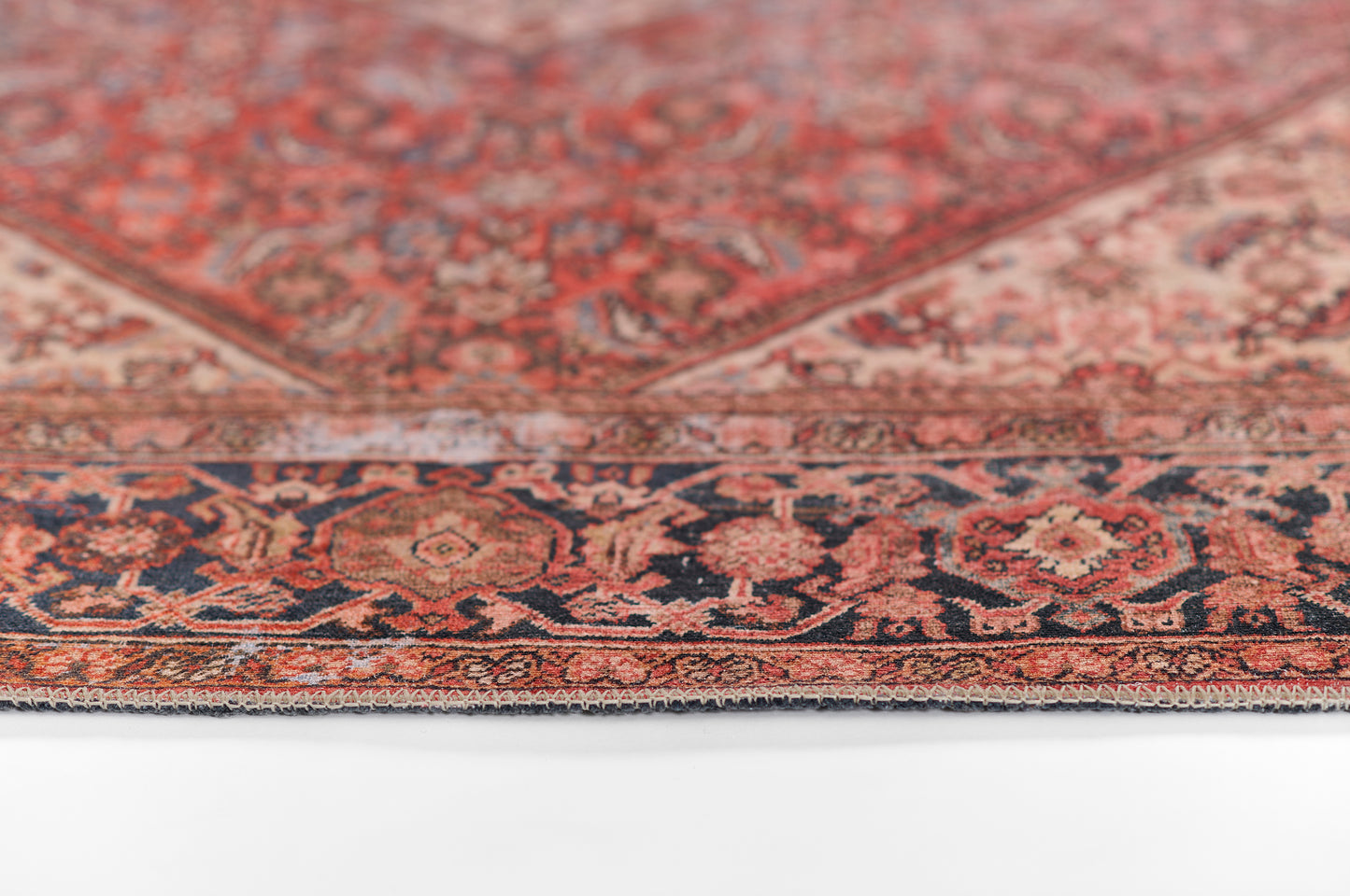 Red Persian-style area rug with navy border & intricate floral motifs; oriental decor.