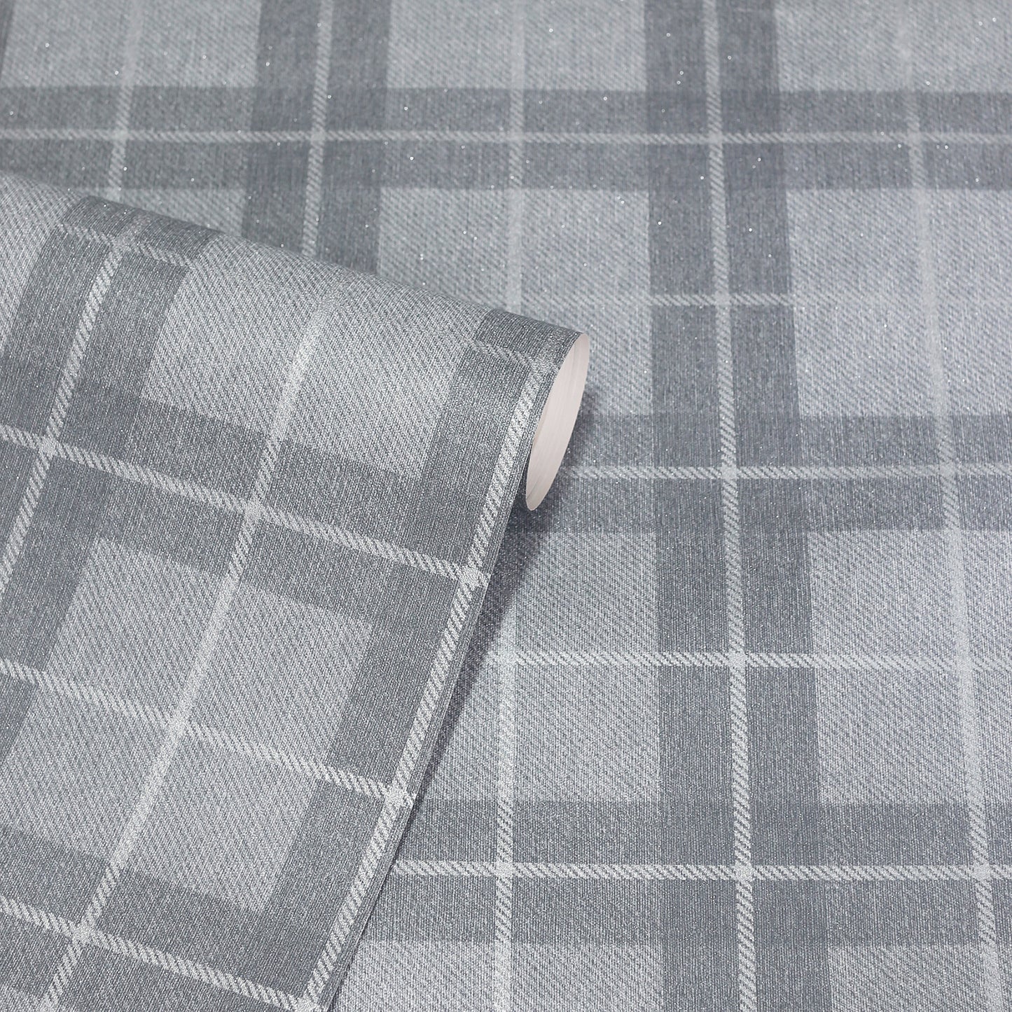 Grey plaid fabric roll with large light and dark grey squares; a woven textile for upholstery or crafts.