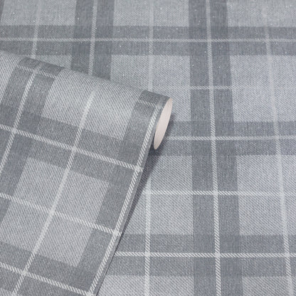 Grey plaid fabric roll with large light and dark grey squares; a woven textile for upholstery or crafts.