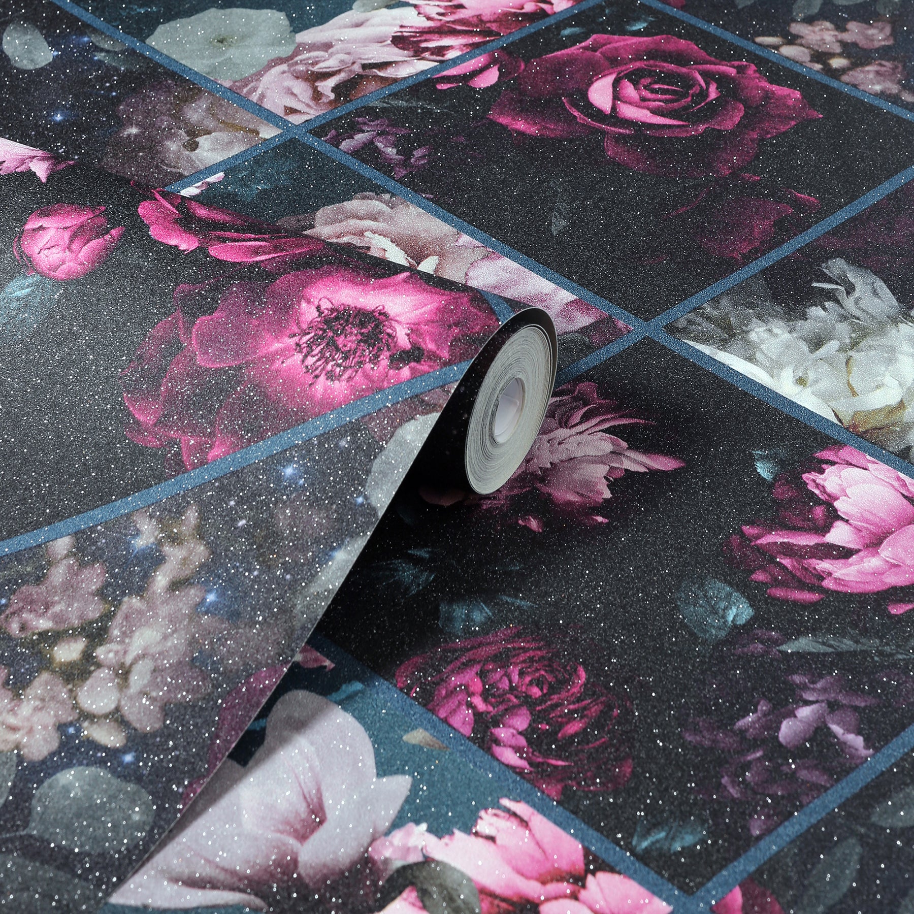 Rolled floral wallpaper with tile-like grid of pink roses on a dark starry night background.