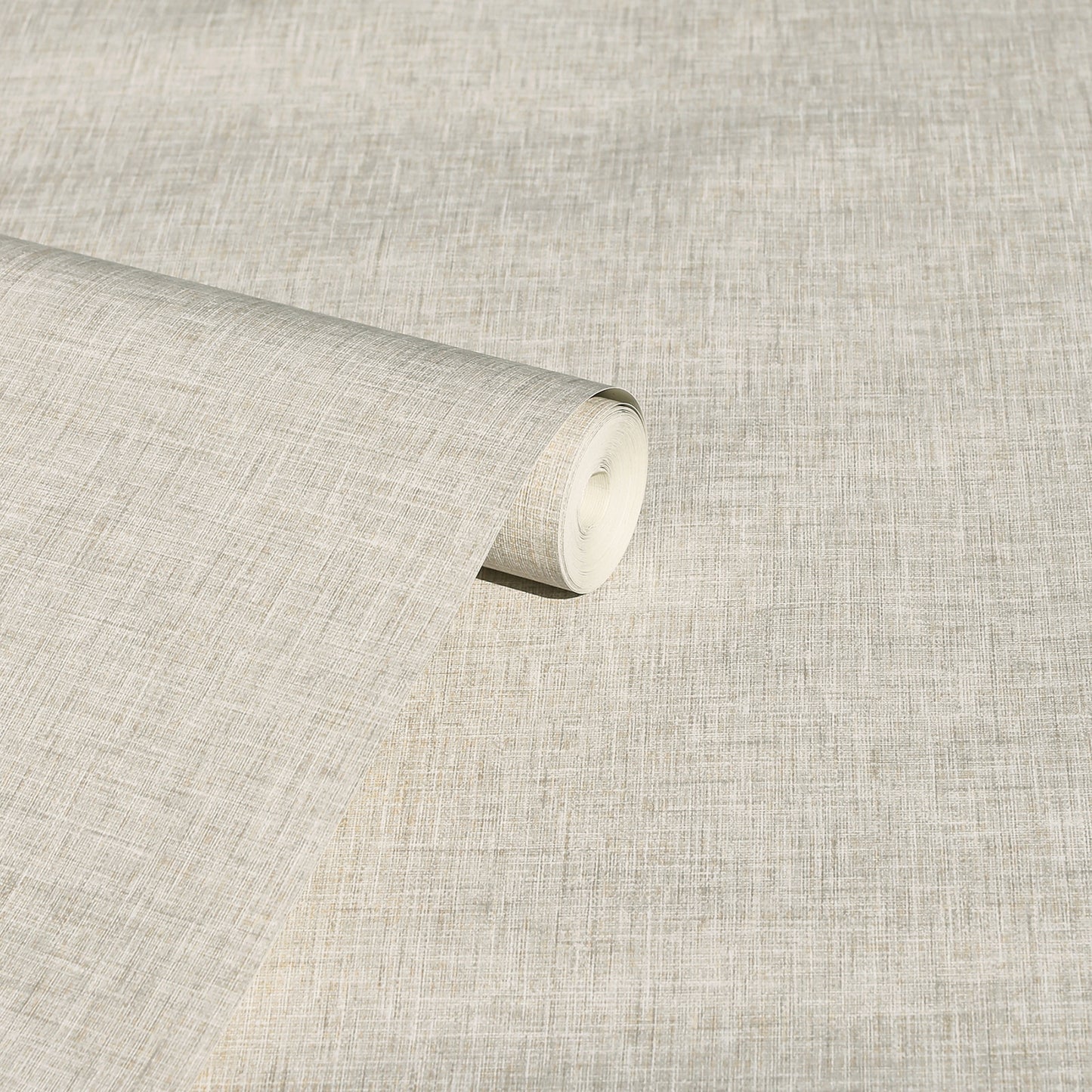 Beige linen-textured fabric roll with visible weave, ideal for upholstery or drapery.