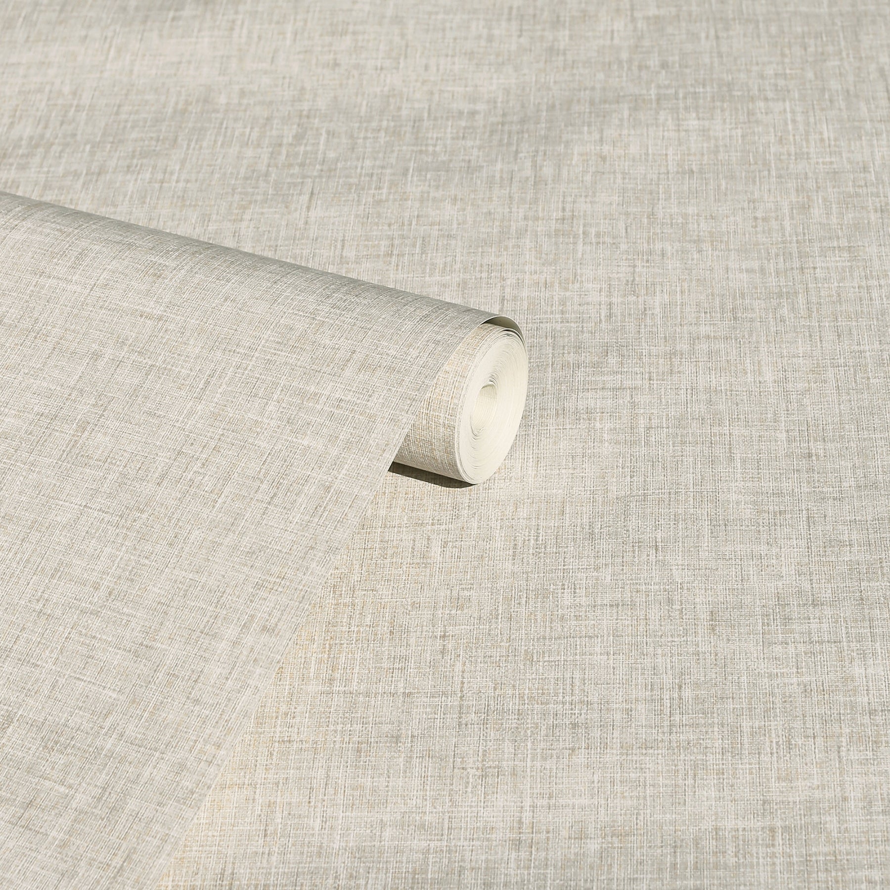 Beige linen-textured fabric roll with visible weave, ideal for upholstery or drapery.