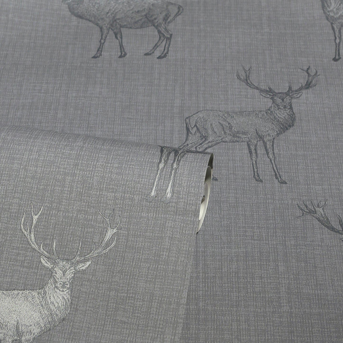 Gray linen-like fabric with deer silhouettes; rolled edge visible, rustic deer motif upholstery textile.