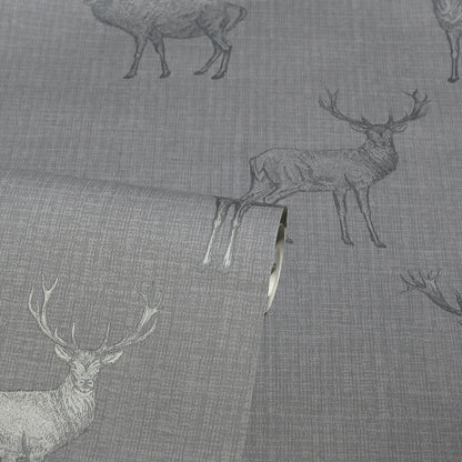 Gray linen-like fabric with deer silhouettes; rolled edge visible, rustic deer motif upholstery textile.