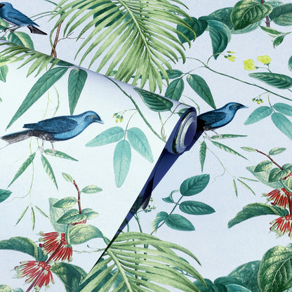 Rolled tropical wallpaper featuring blue birds, green leaves and red flowers on a pale blue background.