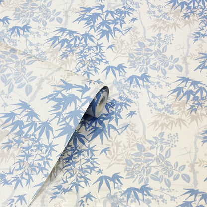 Blue and beige bamboo leaf wallpaper roll with a botanical pattern and rolled edge.
