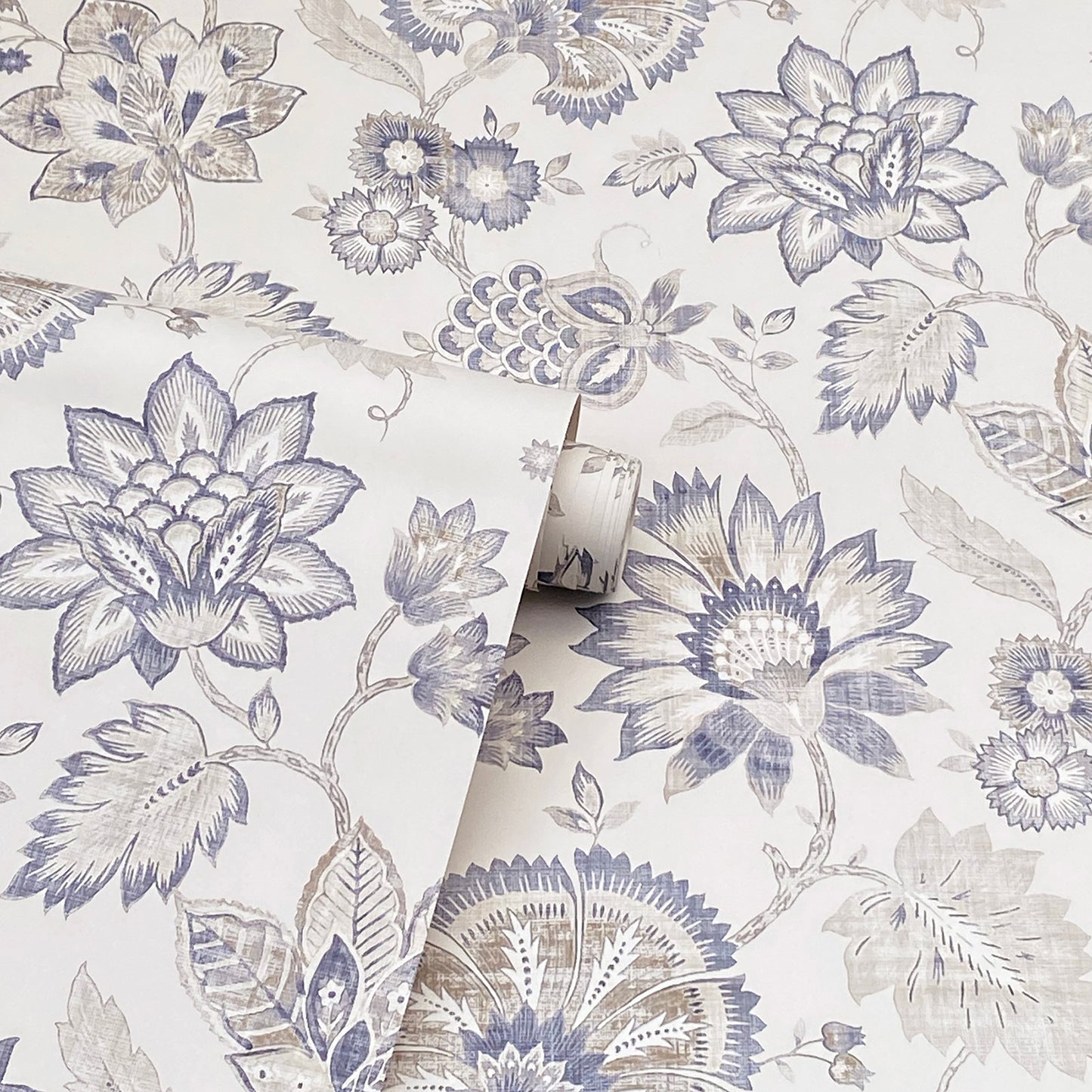 Blue-gray botanical wallpaper featuring large lotus blooms and leaves on white, rolled sample.