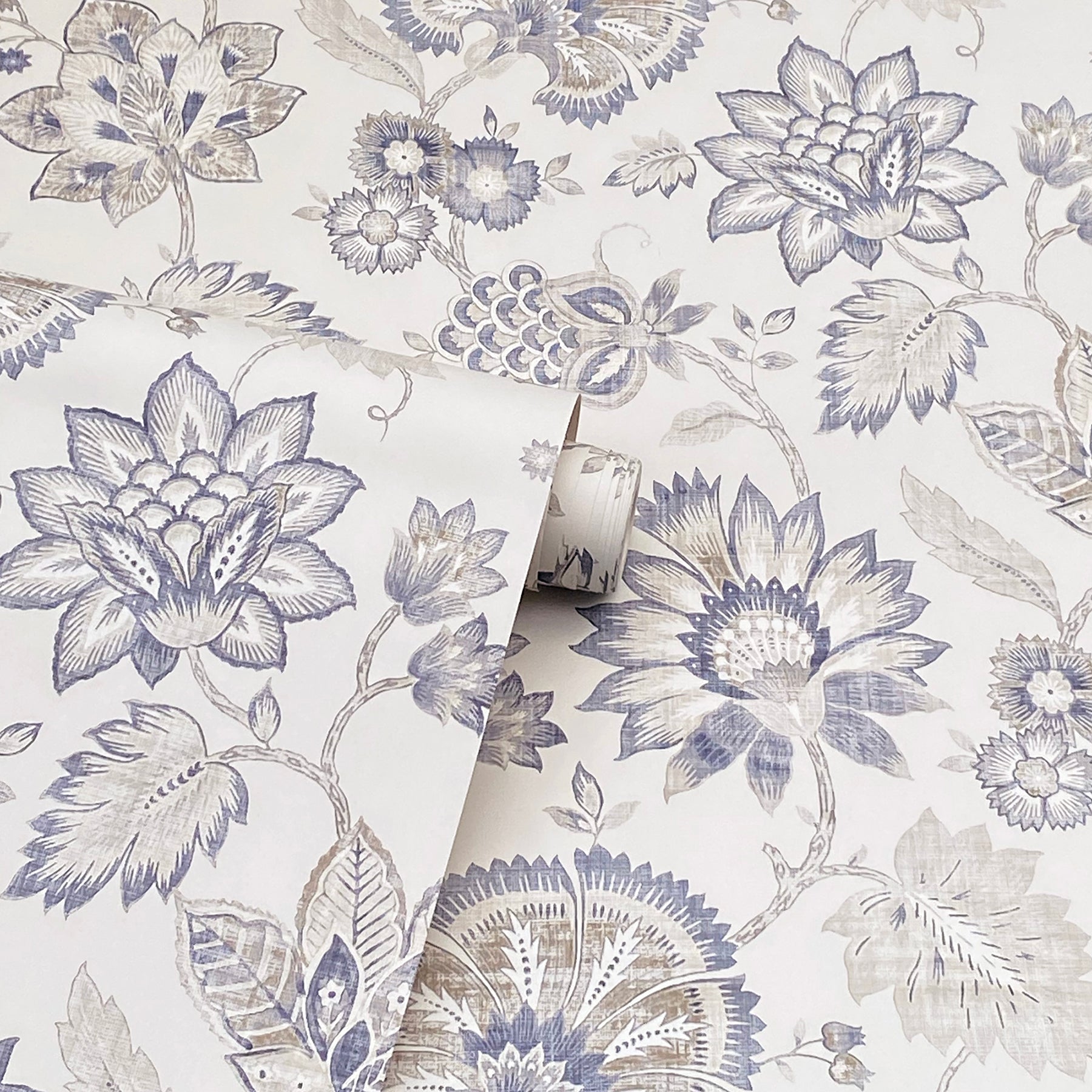 Blue-gray botanical wallpaper featuring large lotus blooms and leaves on white, rolled sample.