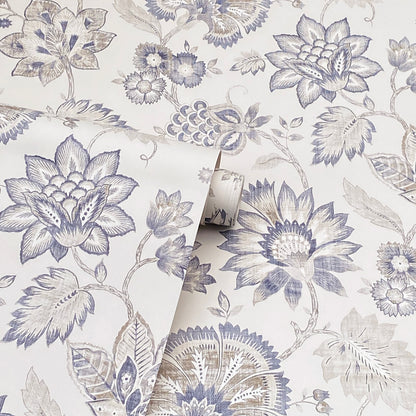 Blue-gray botanical wallpaper featuring large lotus blooms and leaves on white, rolled sample.