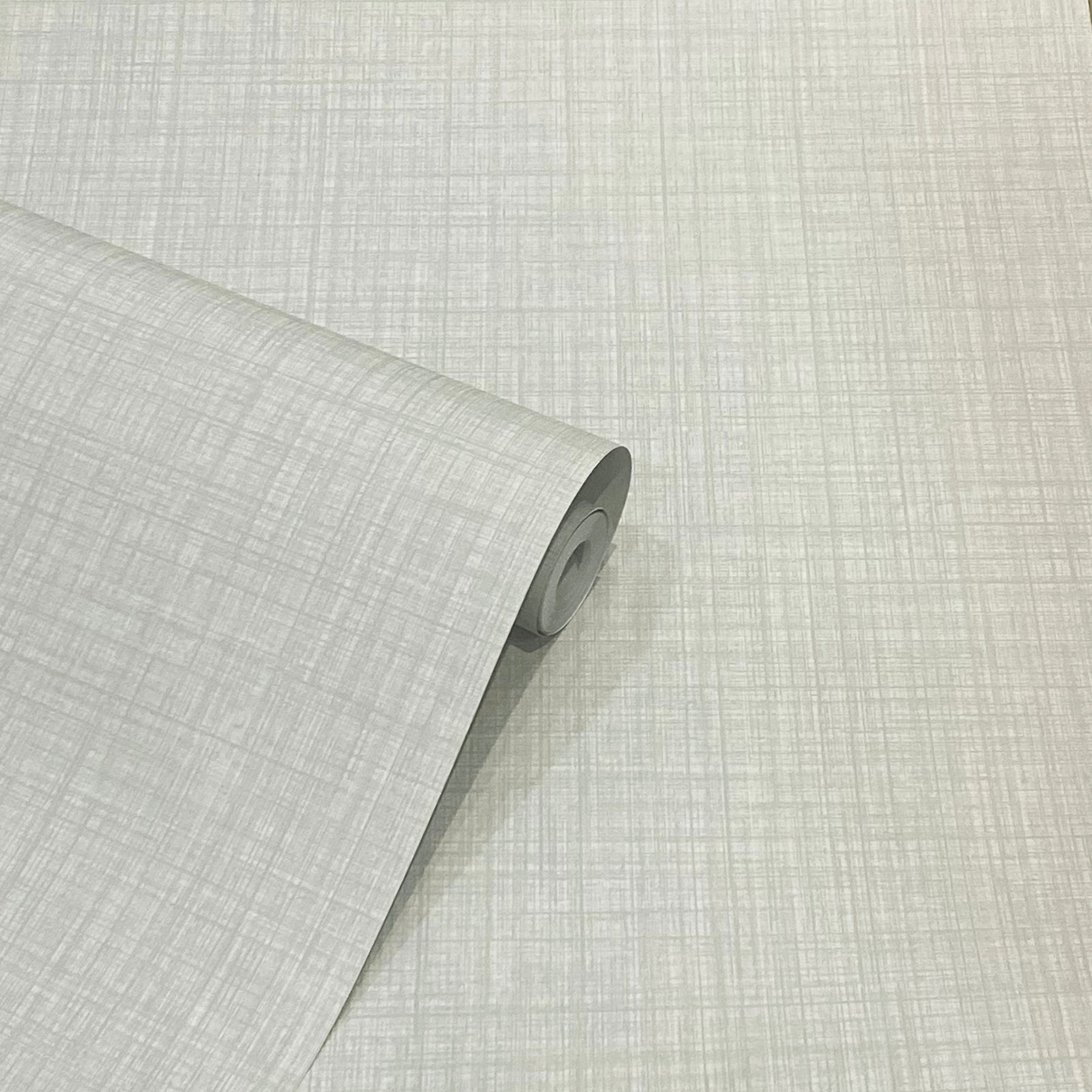 Roll of light gray wallpaper with subtle linen crosshatch texture, partially unrolled.