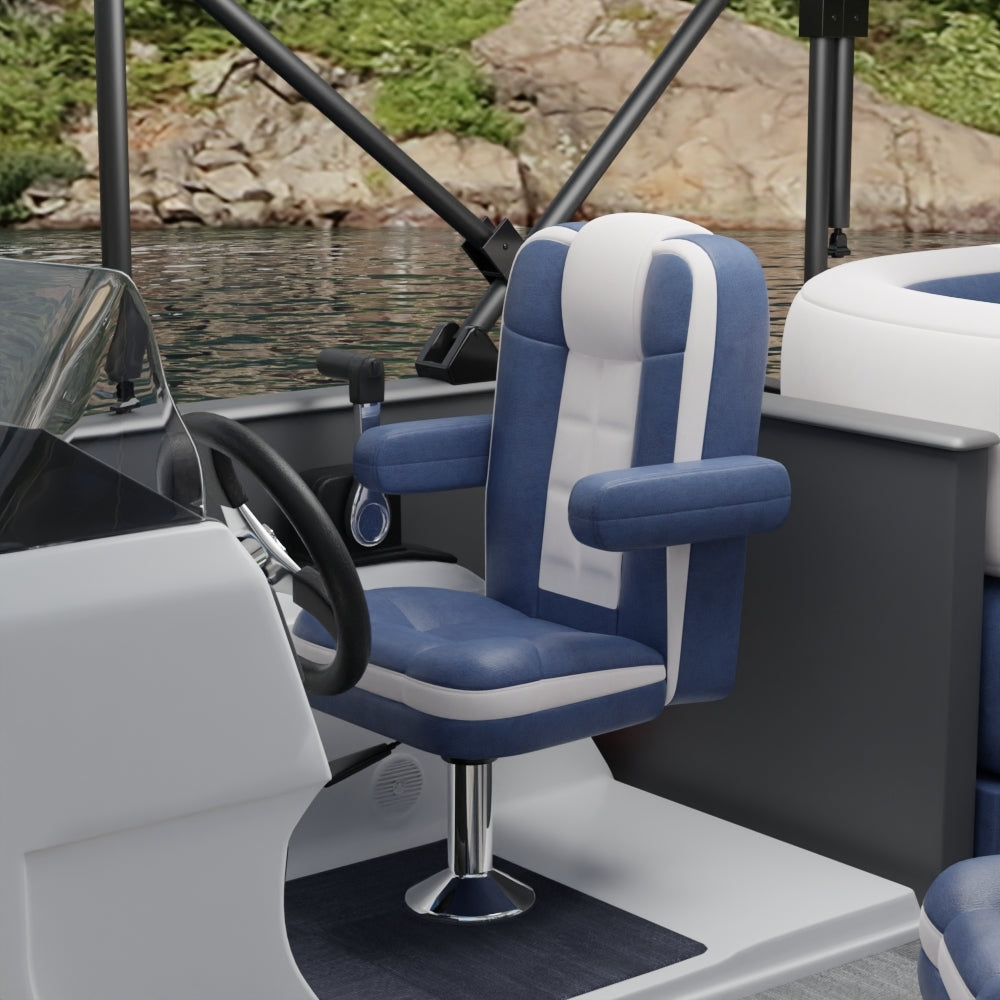Blue & white fabric captain chair with armrests on a boat pedestal, steering wheel visible, water and rocks in the background.