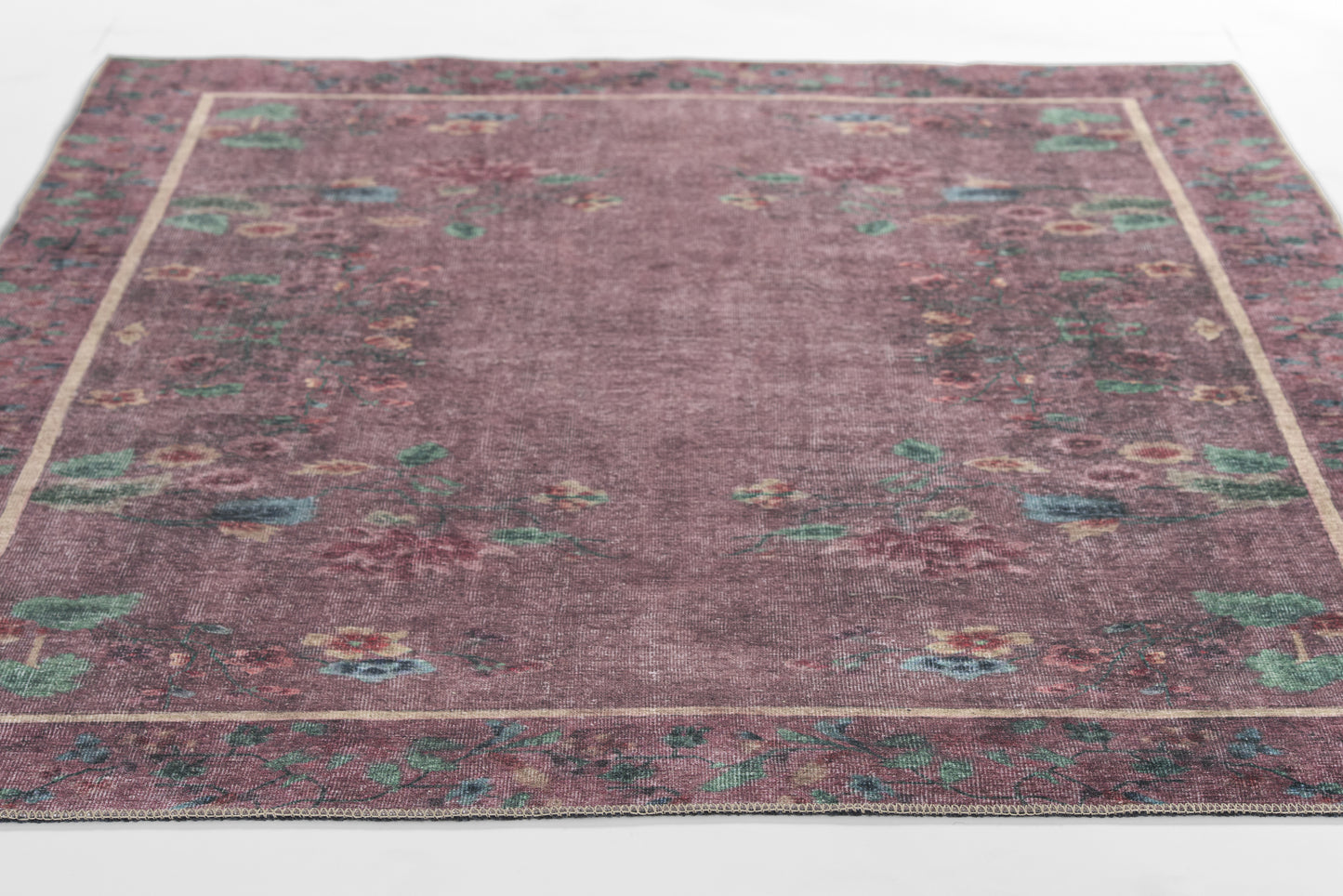 Rectangular Persian-style rug with burgundy central field and ornate teal, blue, and cream floral border.