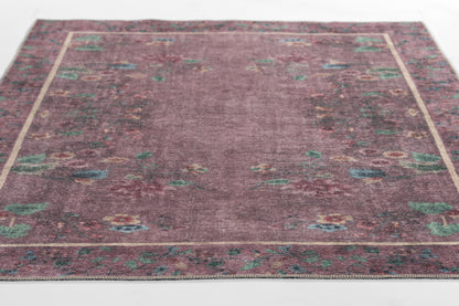 Rectangular Persian-style rug with burgundy central field and ornate teal, blue, and cream floral border.
