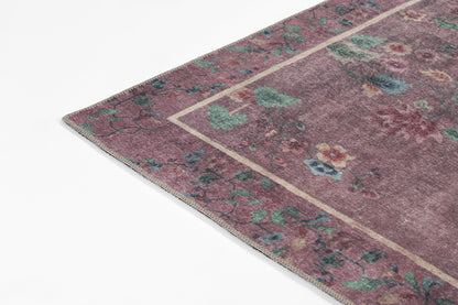 Purple oriental rug with teal and green floral motifs, beige border, corner view, soft wool feel, vintage-inspired decor.