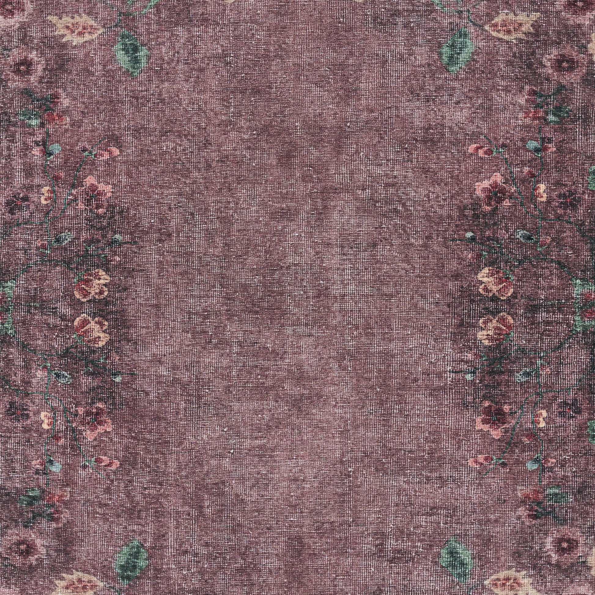 Purple distressed area rug with faded center and pink floral border with green leaves.