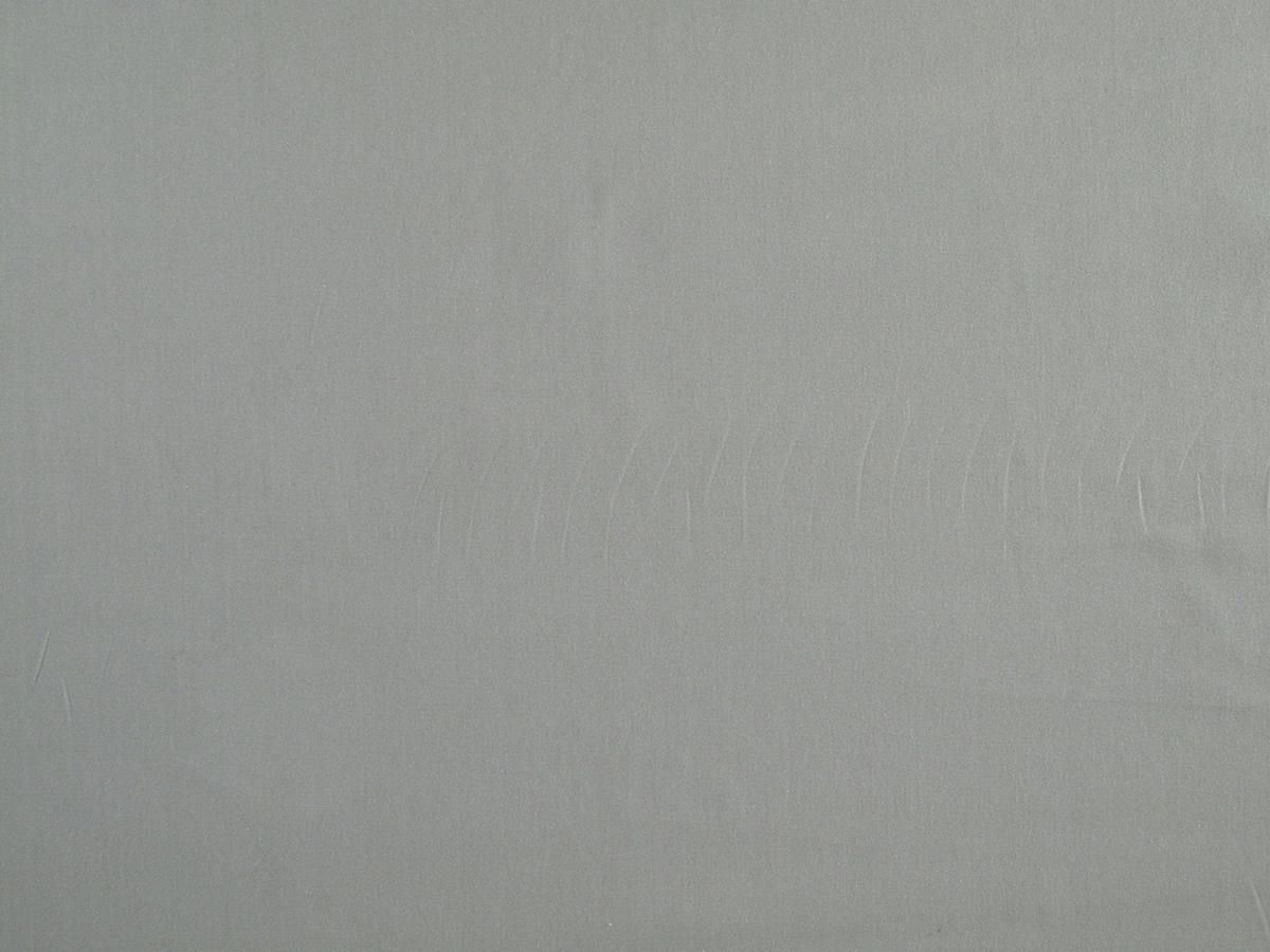 Pale sage fabric swatch with a fine weave and faint wrinkles.