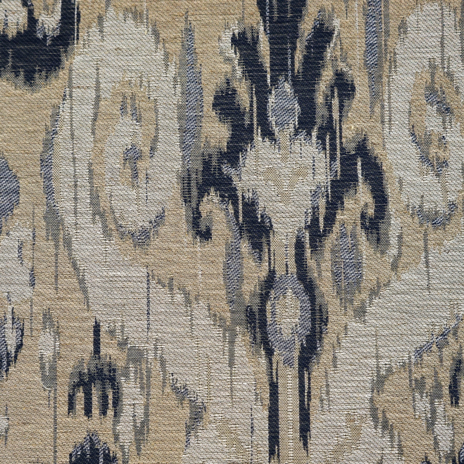 Beige, creme, taupe and blue ikat fabric pattern with woven texture.