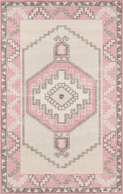Pink and beige boho-style area rug with central geometric medallion and stepped borders.
