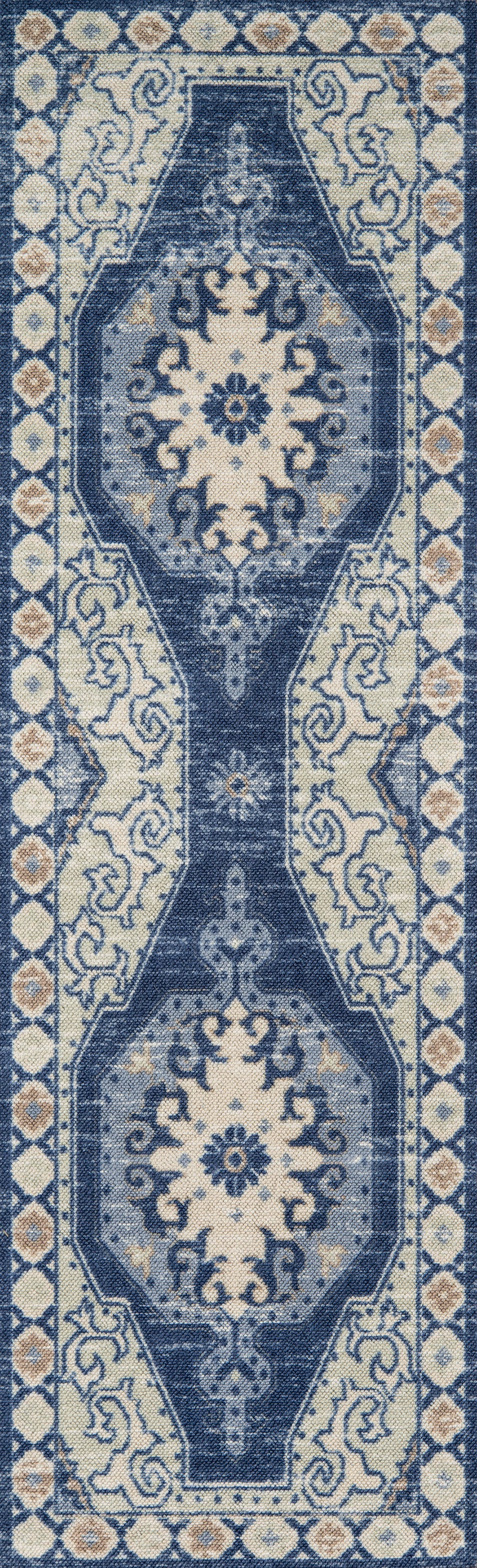 Anatolian-style blue and ivory area rug (7' x 9') with dark navy central medallions and pale floral border.