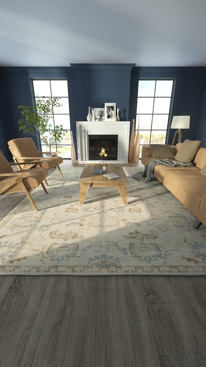 Navy living room with white fireplace, mid-century wood chairs, tan sofa, glass coffee table, patterned rug, large windows.