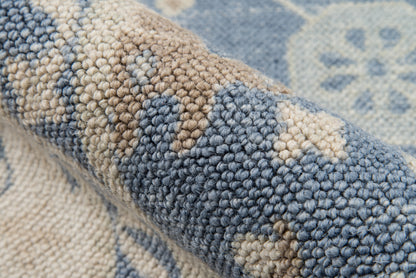Close-up of a blue and beige boucle rug with chunky loop pile and geometric pattern