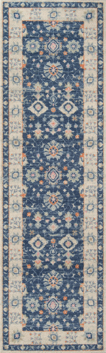 Anatolian-style runner rug with a navy blue field, ivory floral motifs, and a light beige geometric border.