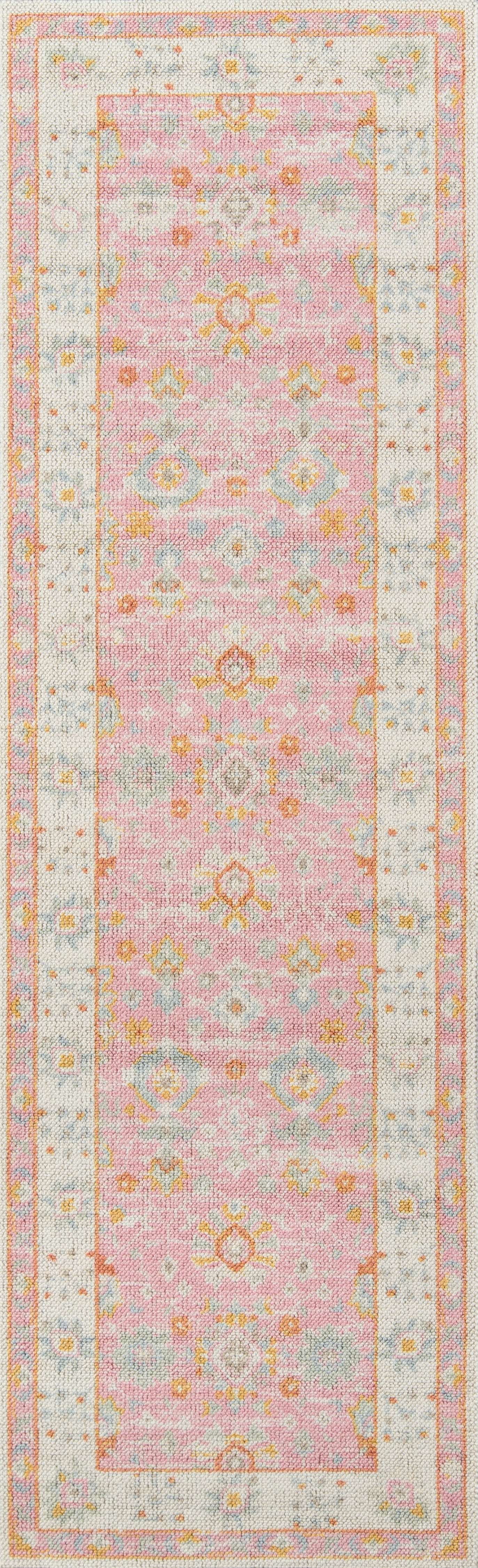 Pink Anatolian runner rug with pastel floral motifs & cream border.
