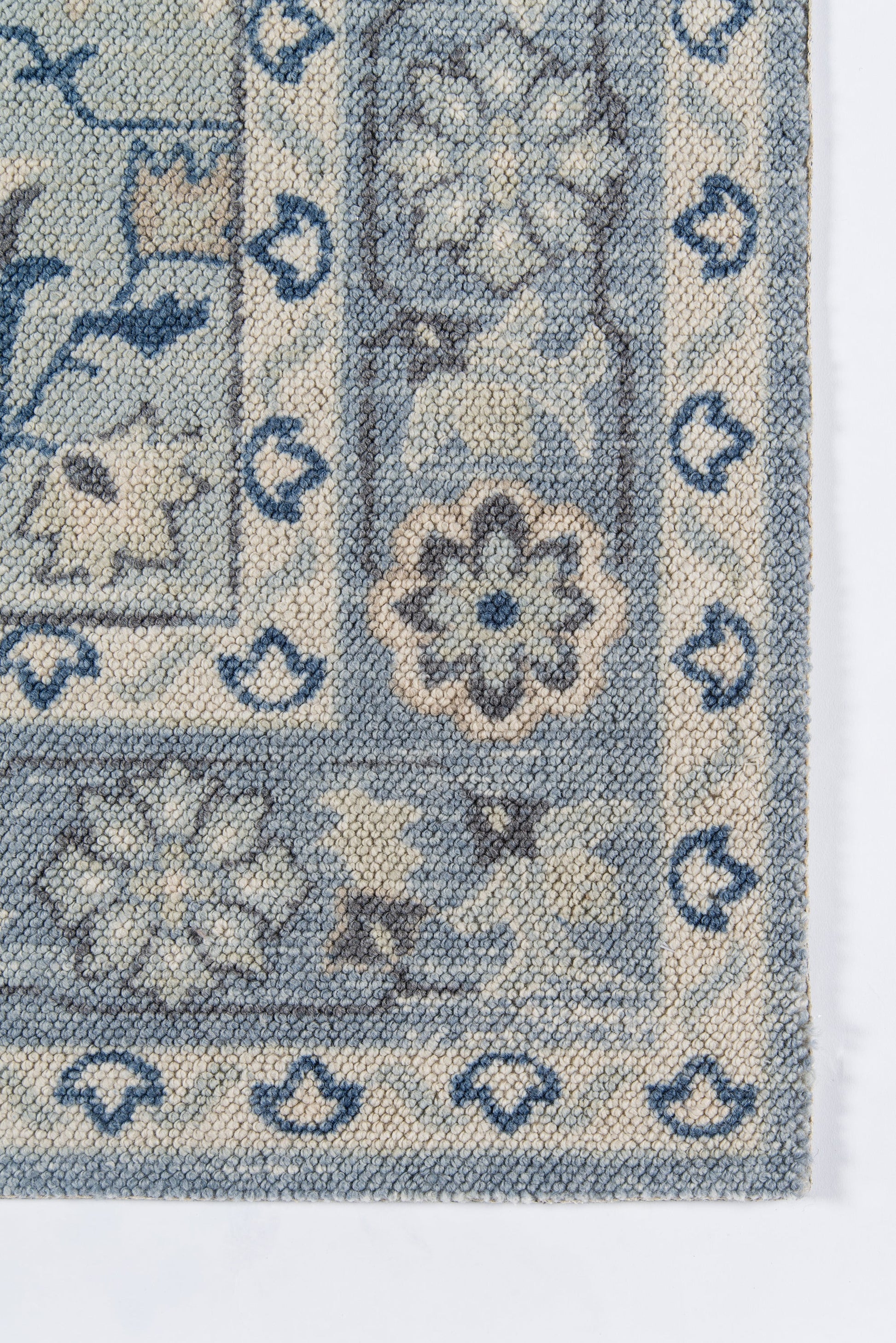 Blue & ivory woven rug with floral motifs & bordered frame in traditional oriental style.