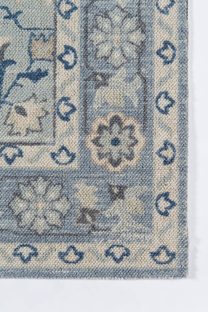 Blue & ivory woven rug with floral motifs & bordered frame in traditional oriental style.