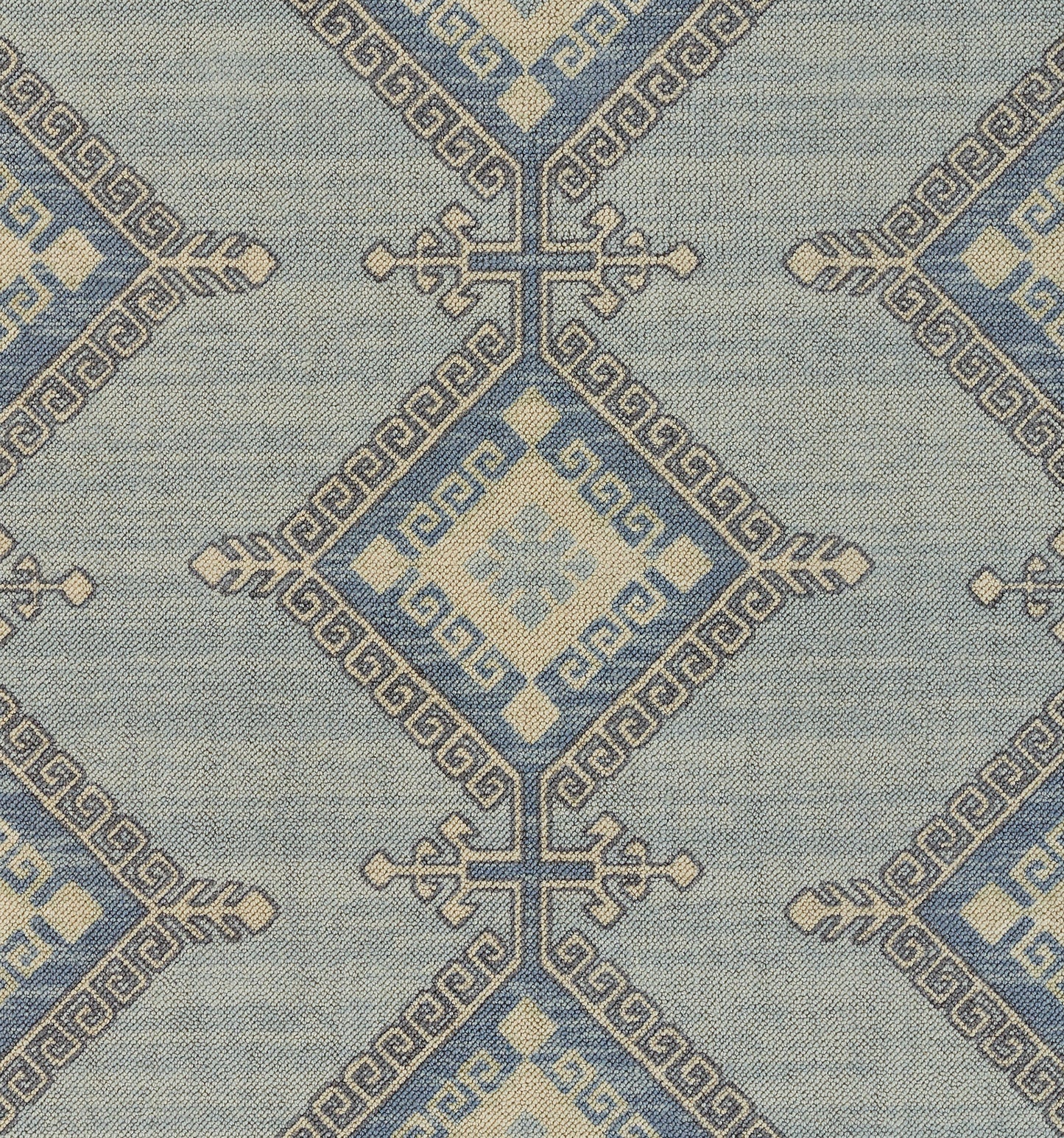 Blue and ivory geometric woven textile with diamond medallions and Greek key borders; decorative rug or wall throw.