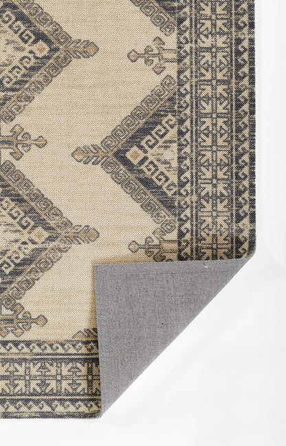 Beige oriental area rug with dark blue geometric borders and diamond motifs; folded corner reveals gray backing.