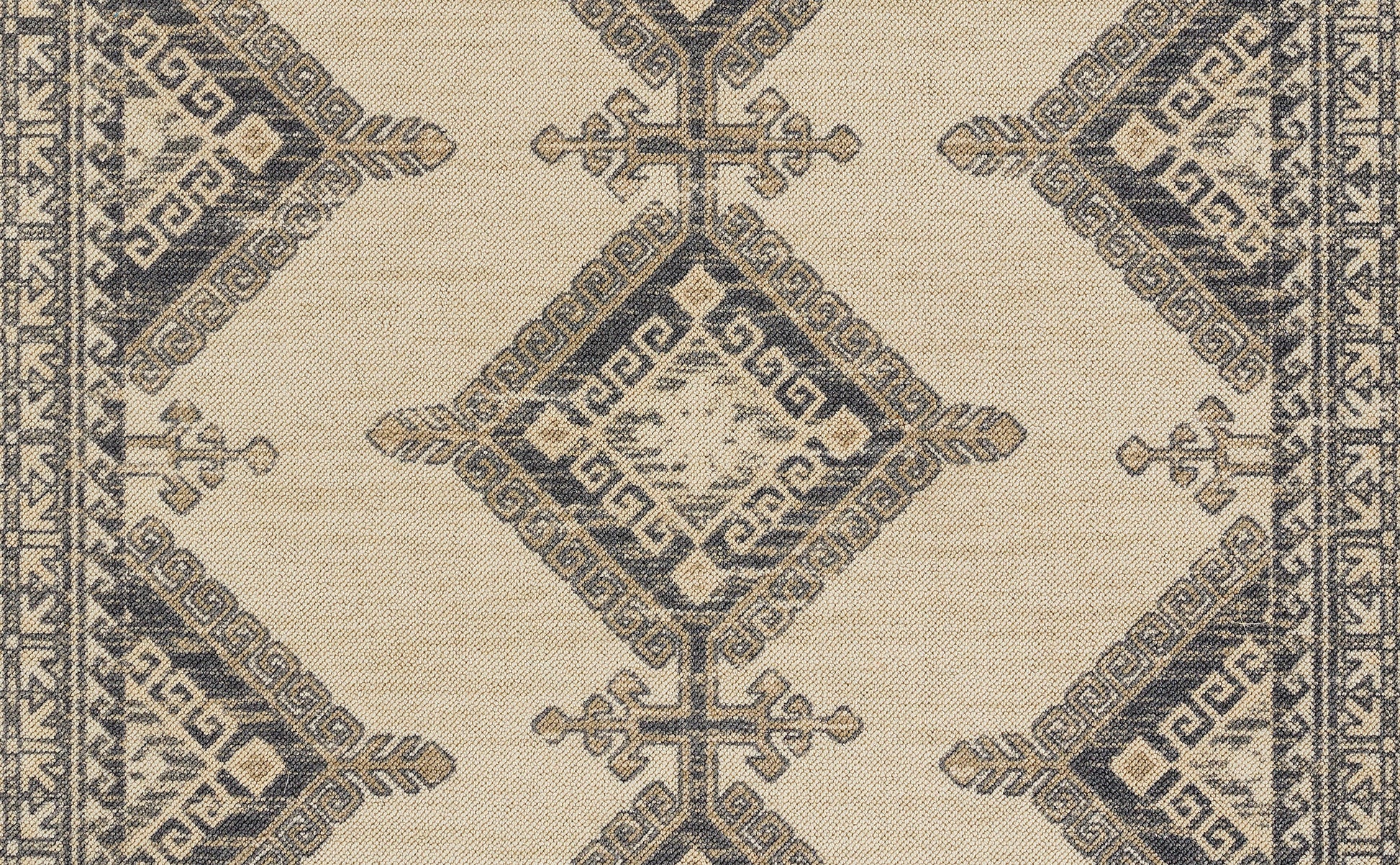 Beige woven rug with navy geometric diamonds and Greek key border pattern, traditional oriental style.
