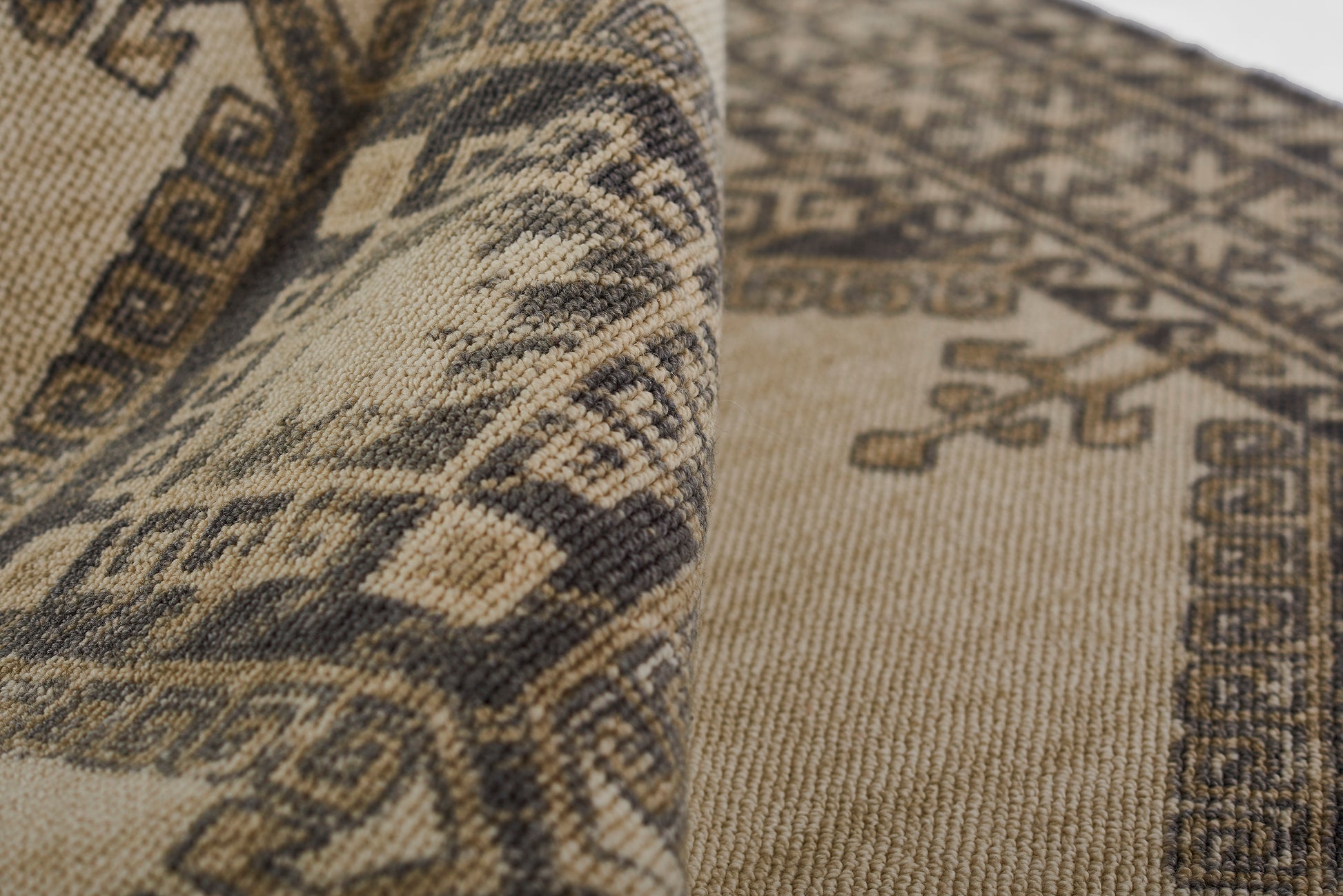 Beige and dark brown woven kilim-style runner rug with geometric borders and medallion motifs, rectangular.