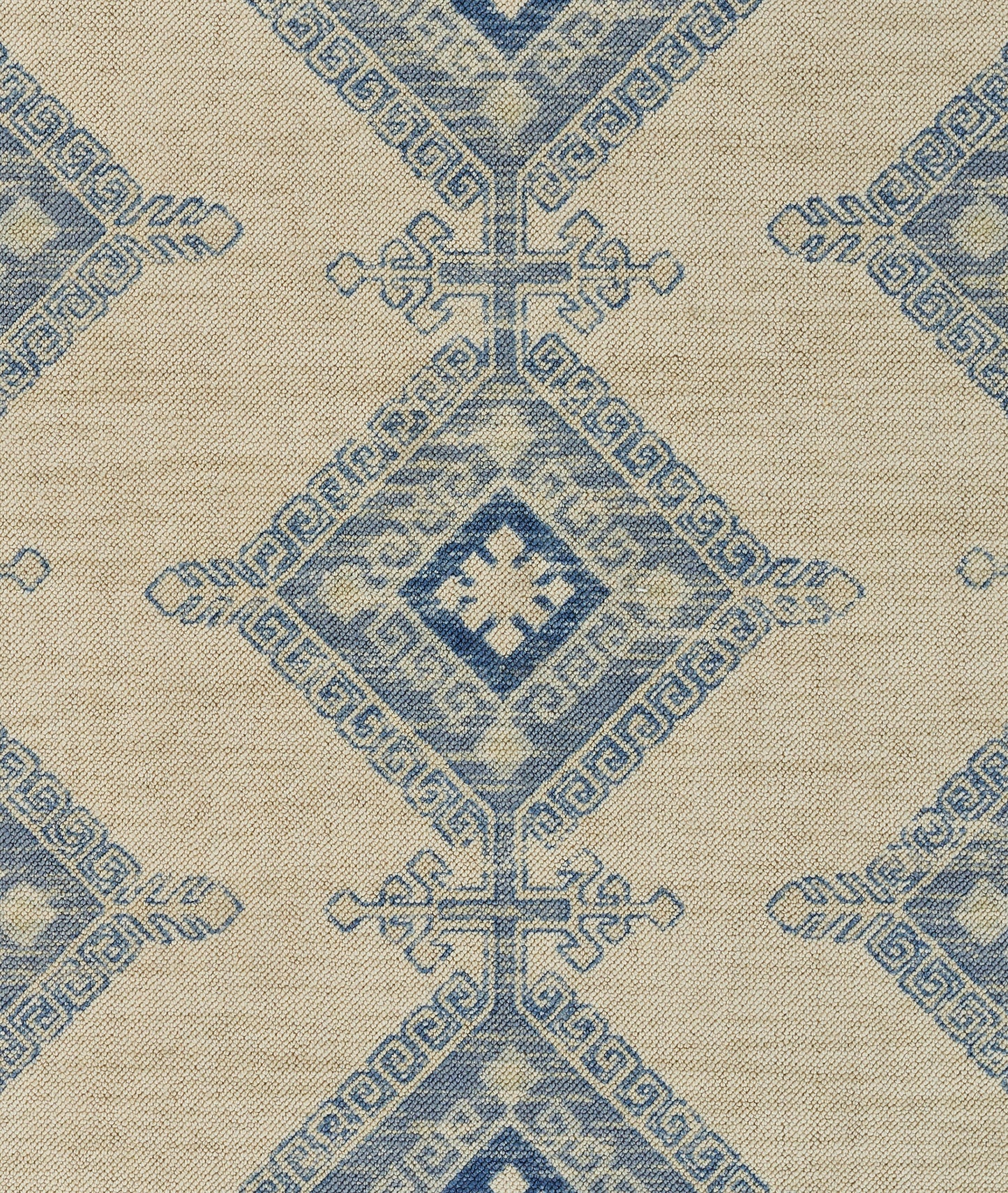 Beige woven rug with blue geometric diamond medallion pattern and decorative borders.