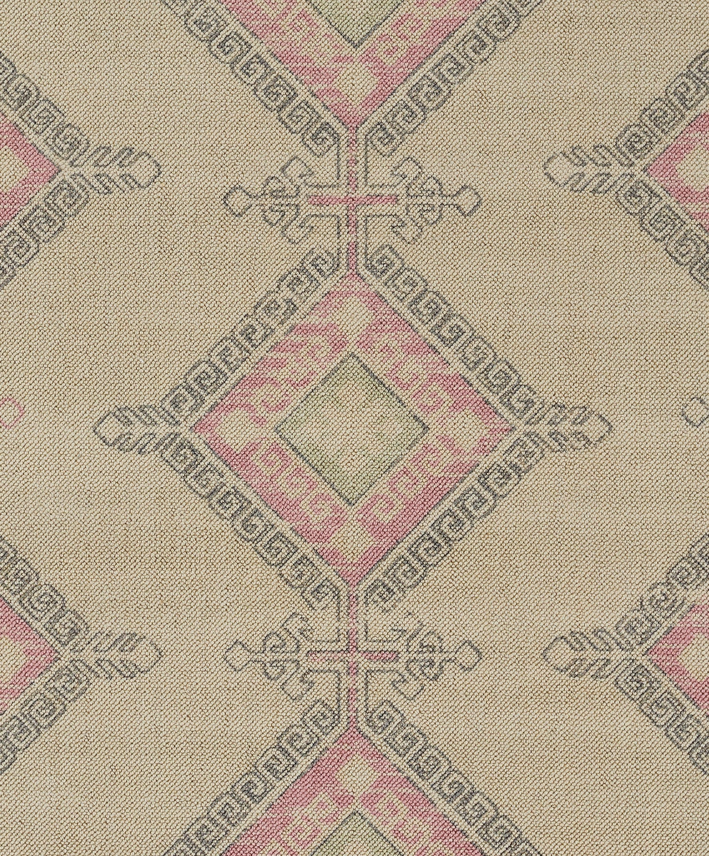 Beige woven fabric with pink diamond motifs and Greek key borders in a repeating geometric jacquard pattern.
