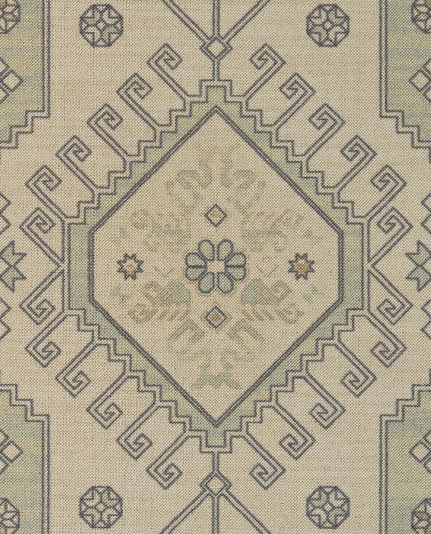 Beige textile with dark blue geometric diamond medallion and stepped borders in a Moroccan-inspired rug pattern.